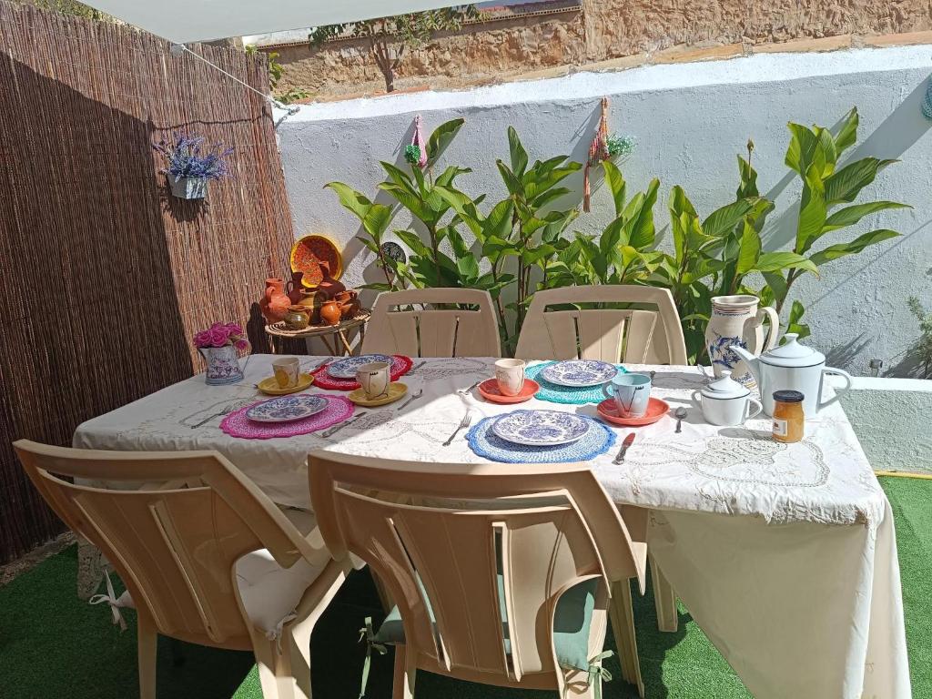 a table with a white table cloth on a table sidx sidx sidx at CASA RURAL ALEGRÍA in Caudete de las Fuentes