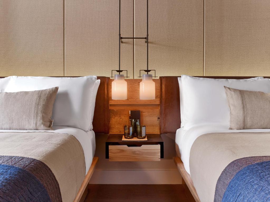 two beds sitting next to each other in a room at 1 Hotel Central Park in New York