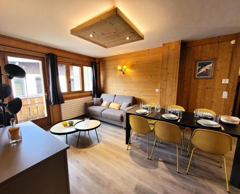 un salon avec un canapé, une table et des chaises dans l'établissement Résidence Le Centre - Appartement au centre 6 personnes MAE-0961, aux Gets