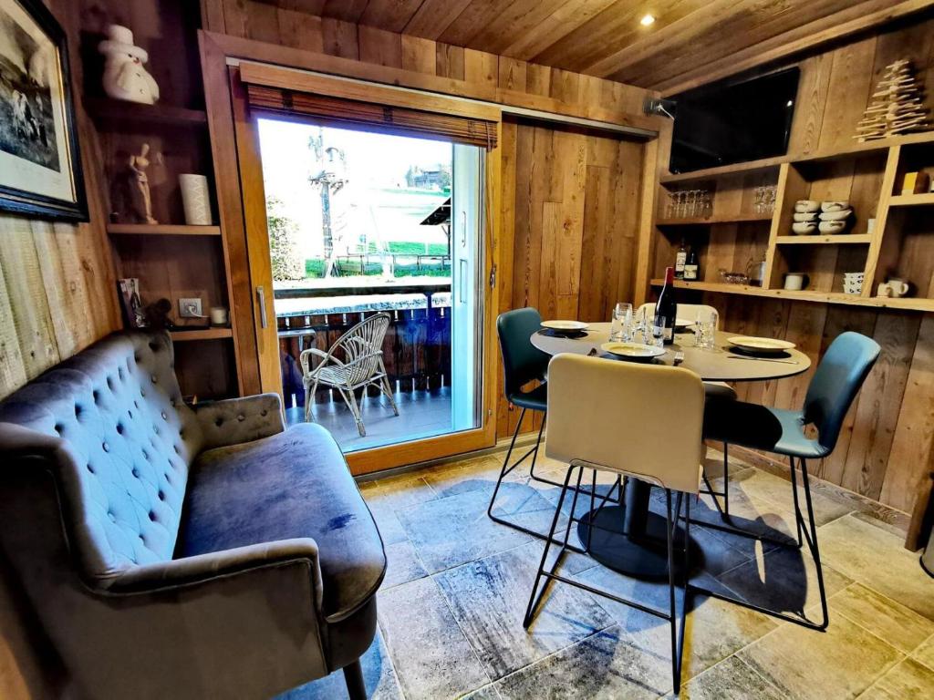 une salle à manger avec une table et des chaises et une fenêtre dans l'établissement Résidence Ranfolly - Charmant studio rénové avec vue pistes MAE-1231, aux Gets