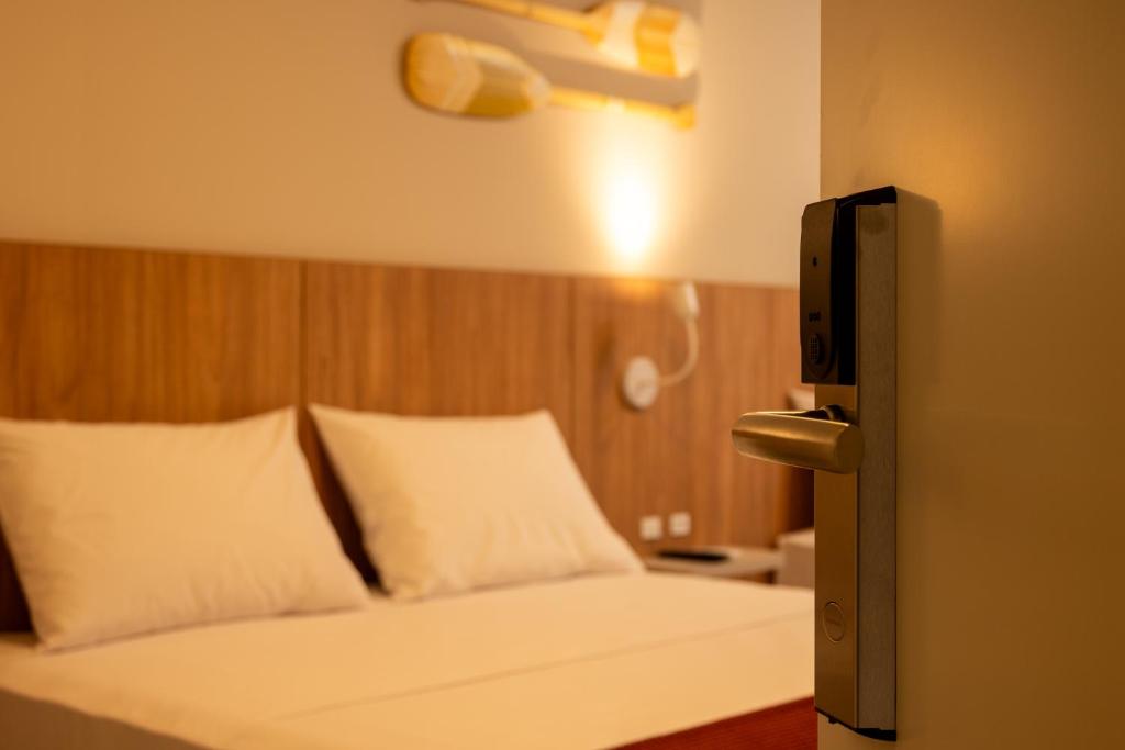 Cama ou camas em um quarto em Pousada Caminho do Bosque