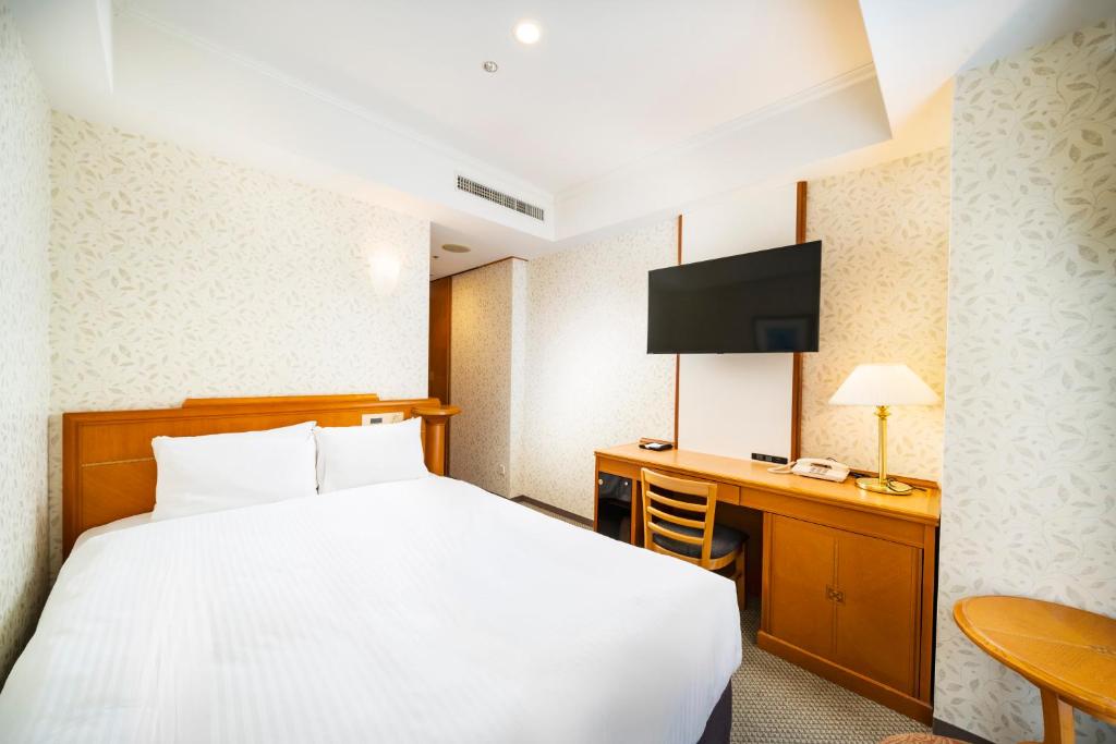 Postel nebo postele na pokoji v ubytování KOKO HOTEL Osaka Shinsaibashi