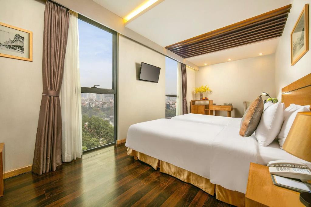 Postel nebo postele na pokoji v ubytování Parkside Sunline Hotel