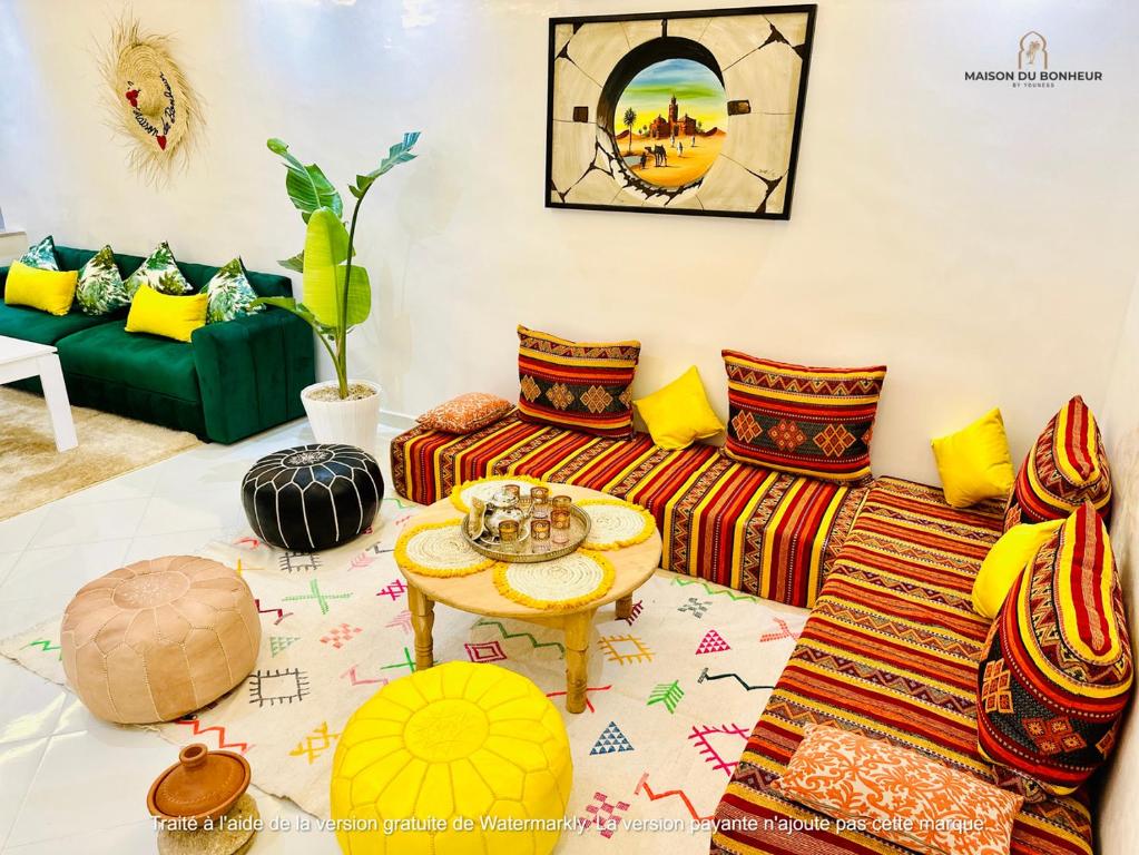 a living room with a couch and a table at Appart F3 de luxe à Gueliz - 5 min de la gare - Piscine, WiFi, parking au coeur de Marrakech in Marrakech