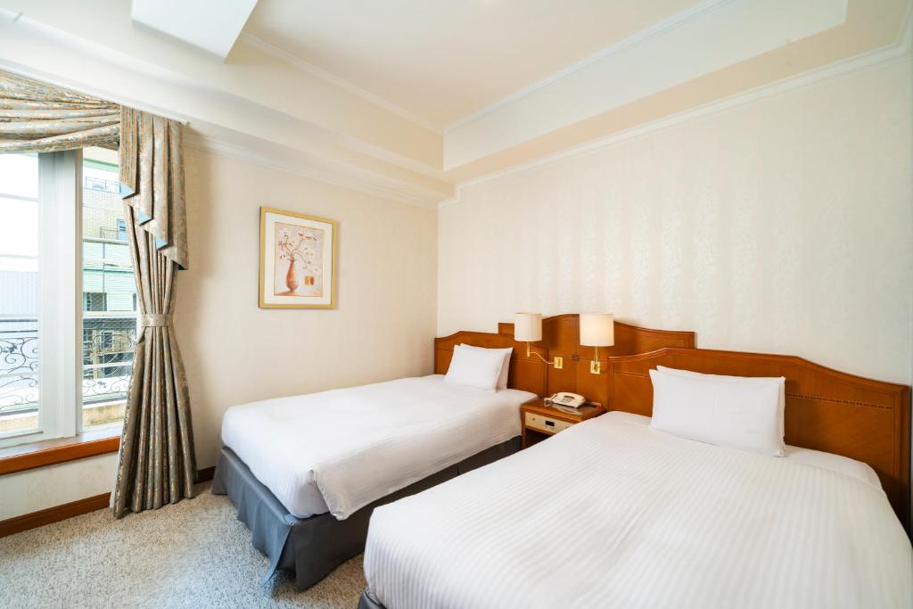 Postel nebo postele na pokoji v ubytování KOKO HOTEL Osaka Shinsaibashi