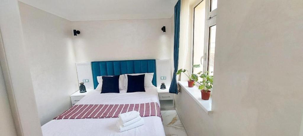 een kleine kamer met twee bedden en een raam bij home hotel registan in Samarkand