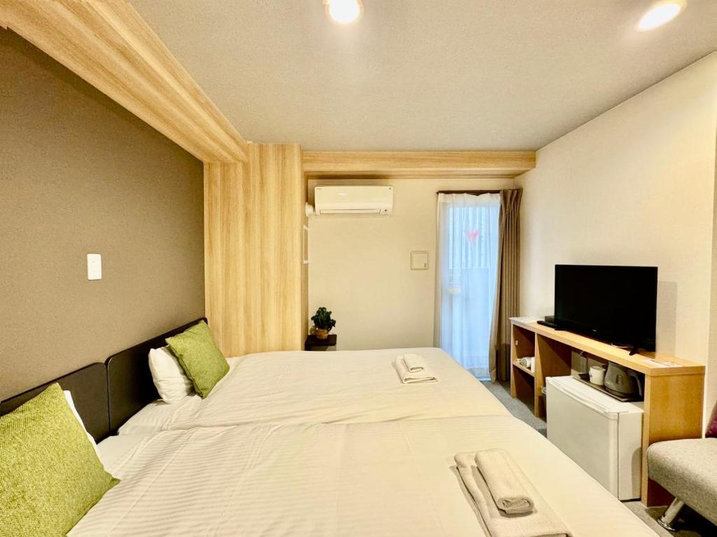 Postel nebo postele na pokoji v ubytování Y&Y NAMBA HOTEL Osaka