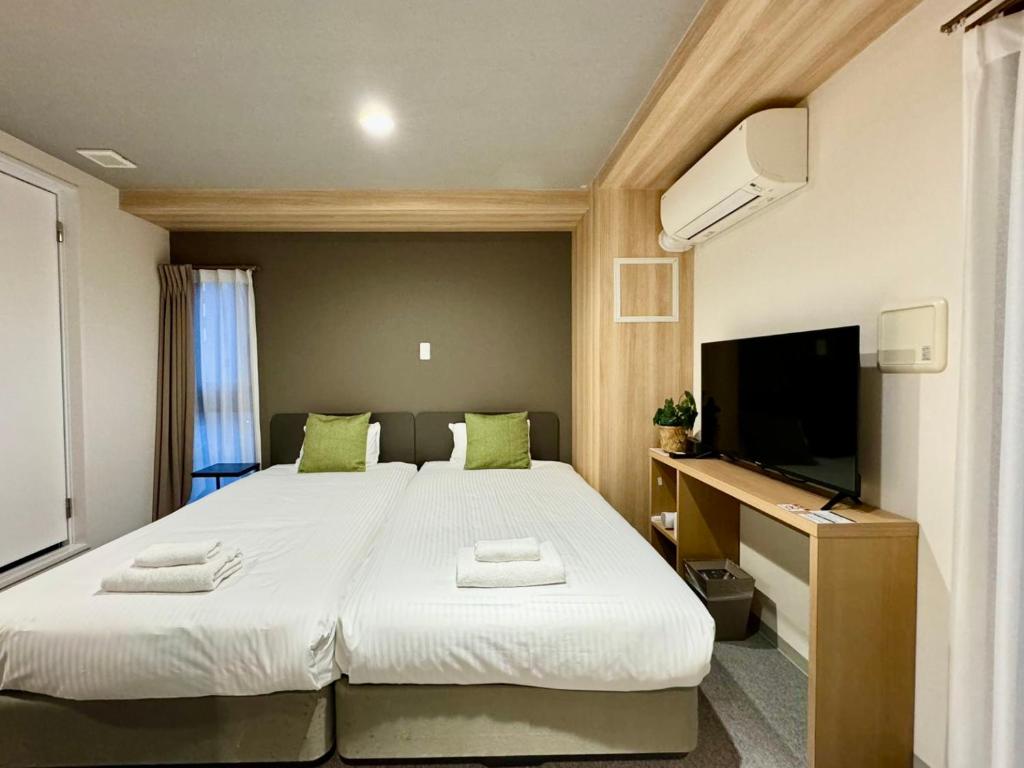 Postel nebo postele na pokoji v ubytování Y&Y NAMBA HOTEL Osaka