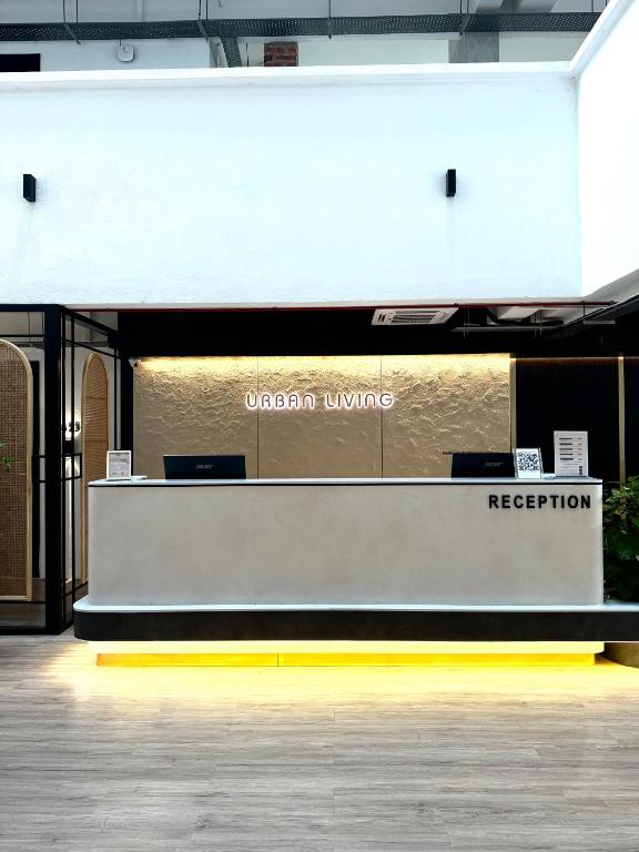 A contemporary reception counter sits beneath the Urban Living sign.