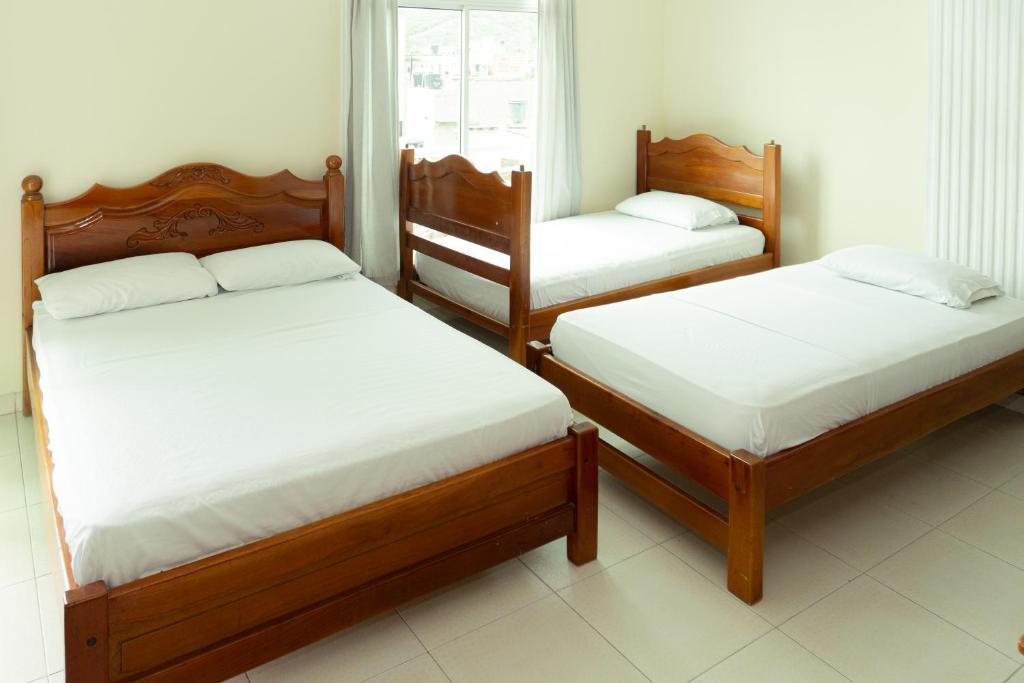 Postel nebo postele na pokoji v ubytování HOTEL GAIRA MAR