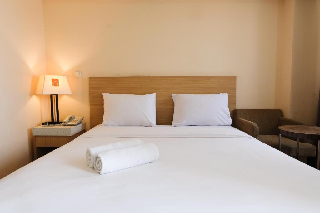 Postel nebo postele na pokoji v ubytování Strategic and Comfy 1BR at Braga City Walk Apartment By Travelio