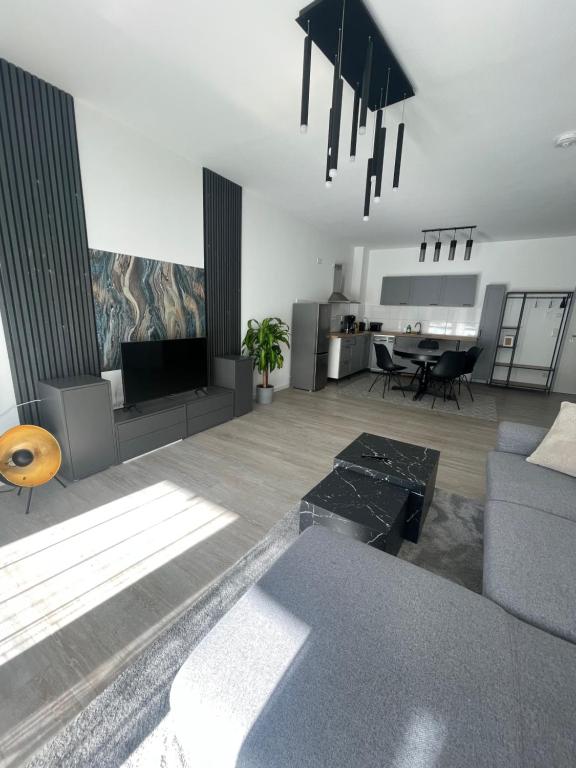 a living room with a couch and a table at Deluxe Apartment Ruhr Oase, Neubau, 4 Personen, Parkplatz, in Bochum