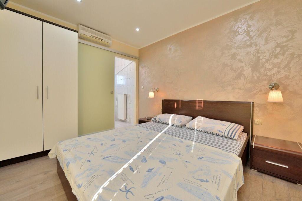 Postel nebo postele na pokoji v ubytování Apartments Tomo