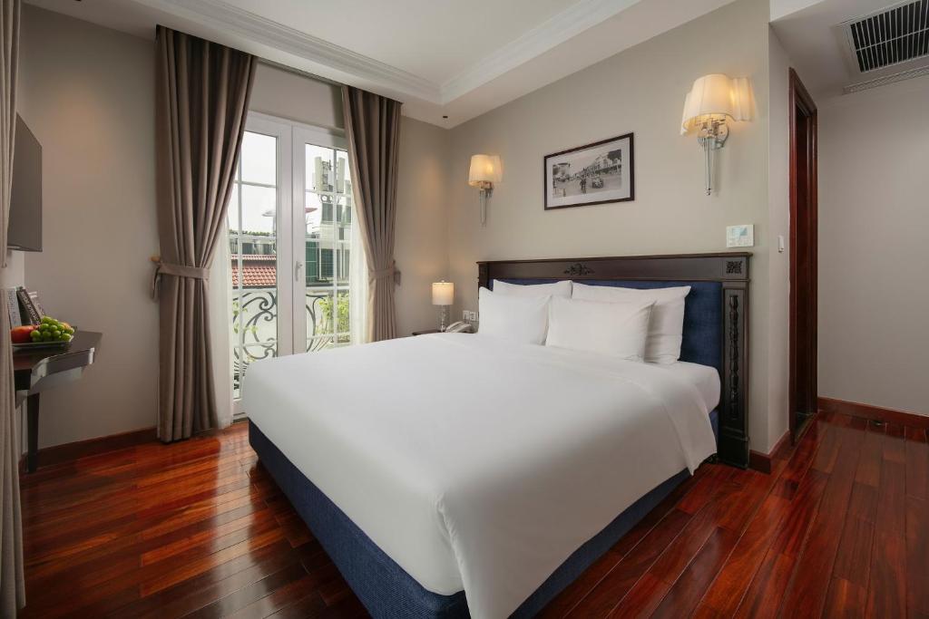 Postel nebo postele na pokoji v ubytování Sunline Central Hotel