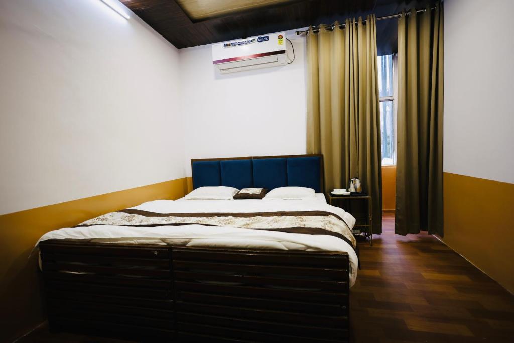 a bedroom with a large bed in a room at HOTEL SHIVIKA in Bikaner