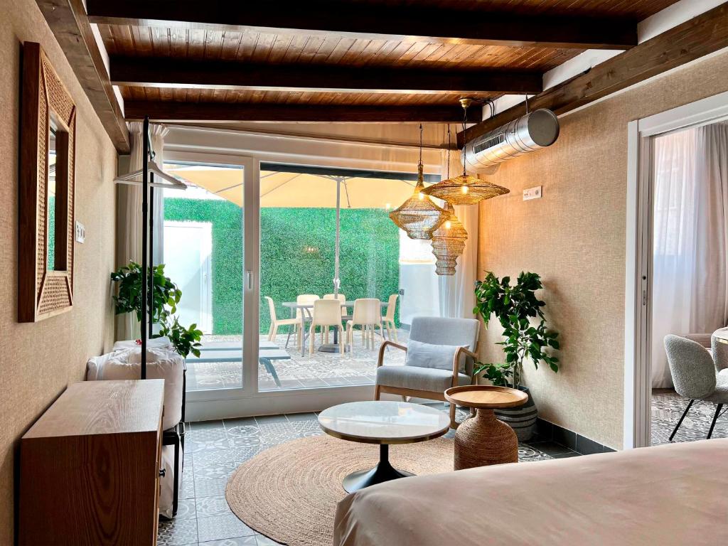 a room with a bed and a table and a patio at Apartamentos Realejo Campo del Príncipe 3000 in Granada