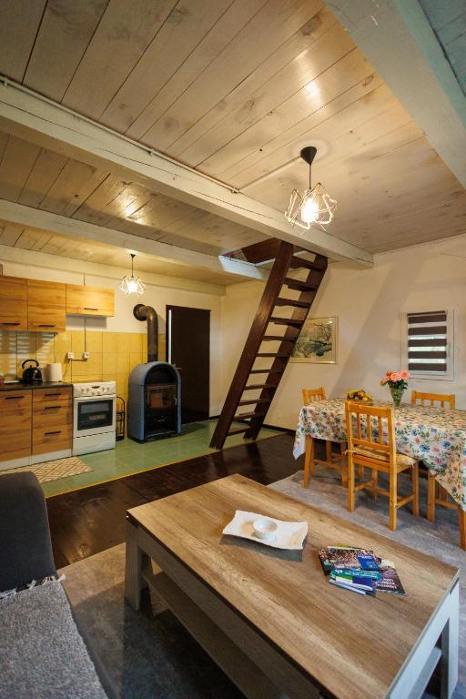 a living room and kitchen with a spiral staircase in a house at Studio apartman Farah in Bihać