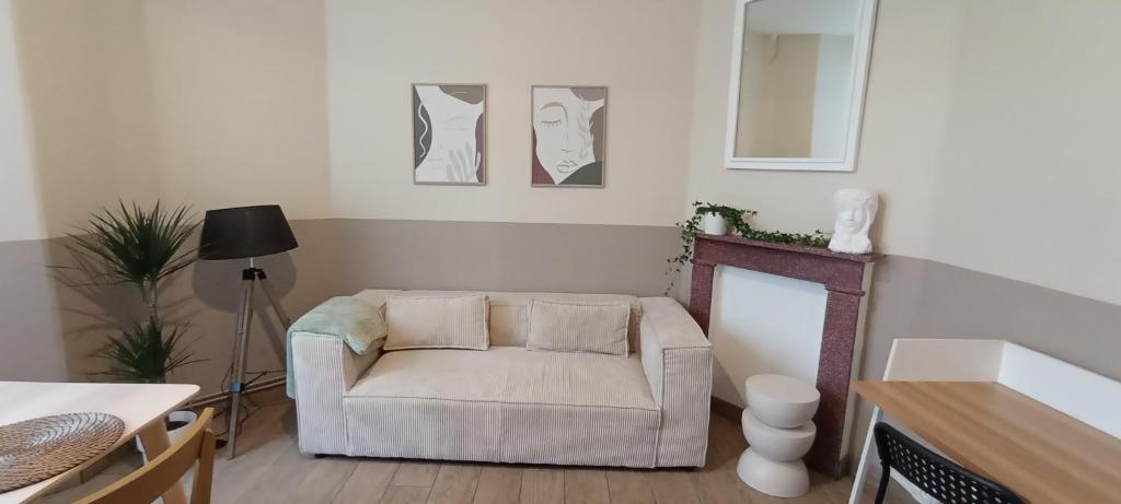 a living room with a couch and a table at Au Coeur de LilleMoulins in Lille
