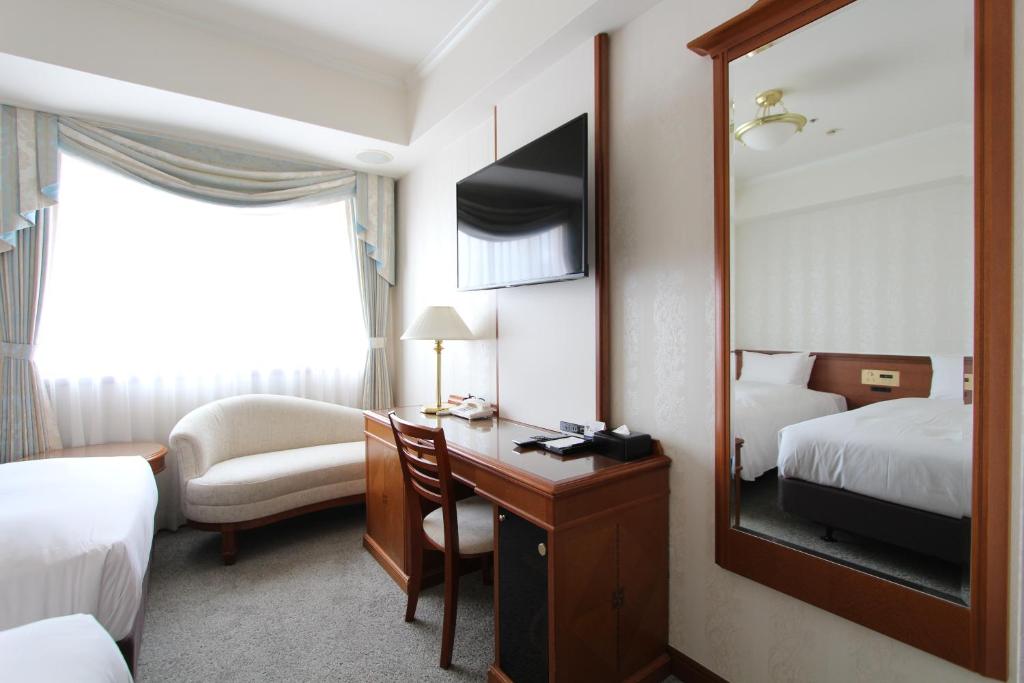 Postel nebo postele na pokoji v ubytování KOKO HOTEL Osaka Shinsaibashi