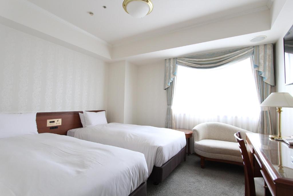 Postel nebo postele na pokoji v ubytování KOKO HOTEL Osaka Shinsaibashi