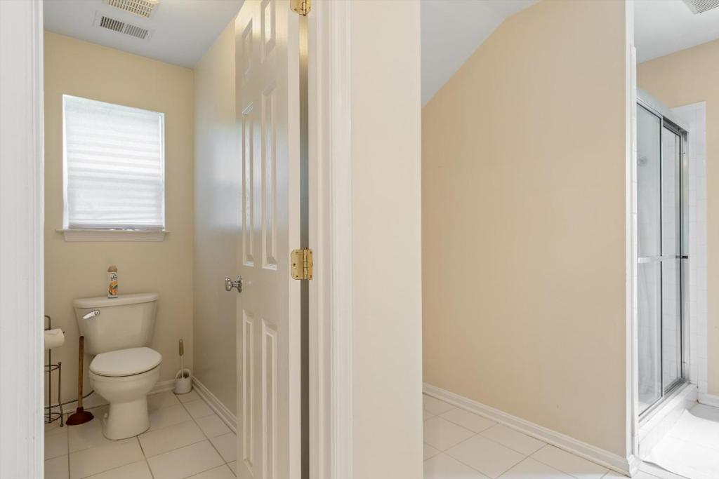 a bathroom with a toilet and a walk in shower at Entire 4-BR in Beloved DC Area Takoma Park in Takoma Park