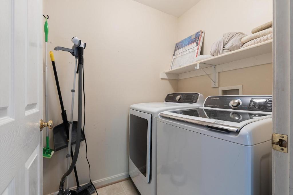 a small laundry room with a washer and dryer at Entire 4-BR in Beloved DC Area Takoma Park in Takoma Park