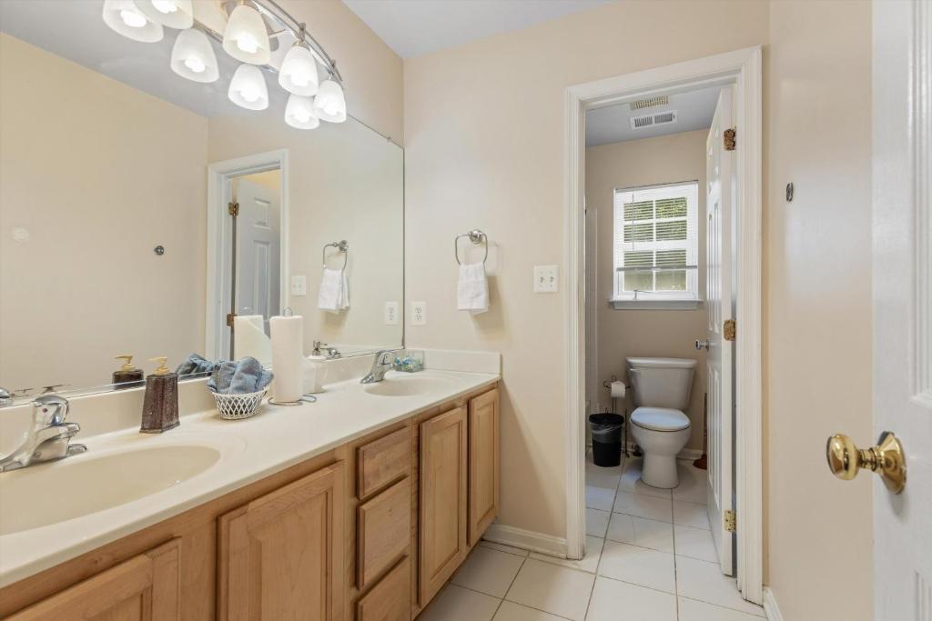 a white bathroom with a sink and a toilet at Entire 4-BR in Beloved DC Area Takoma Park in Takoma Park