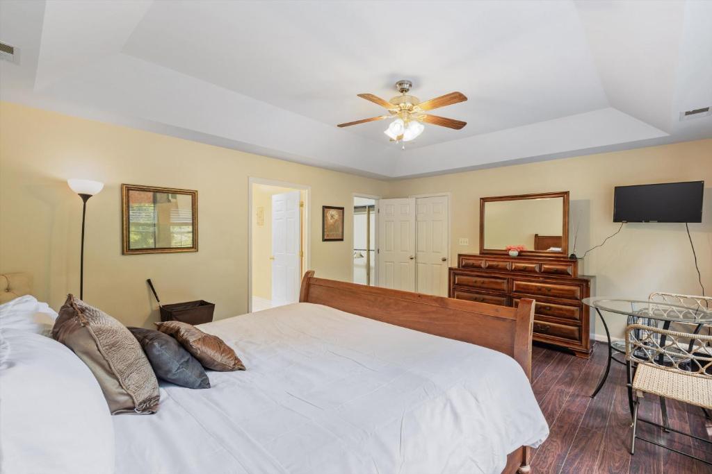 a bedroom with a bed and a ceiling fan at Entire 4-BR in Beloved DC Area Takoma Park in Takoma Park