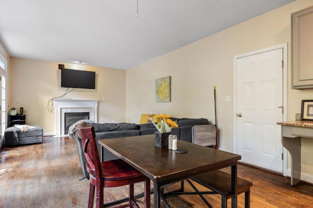 a living room with a table and a couch at Entire 4-BR in Beloved DC Area Takoma Park in Takoma Park