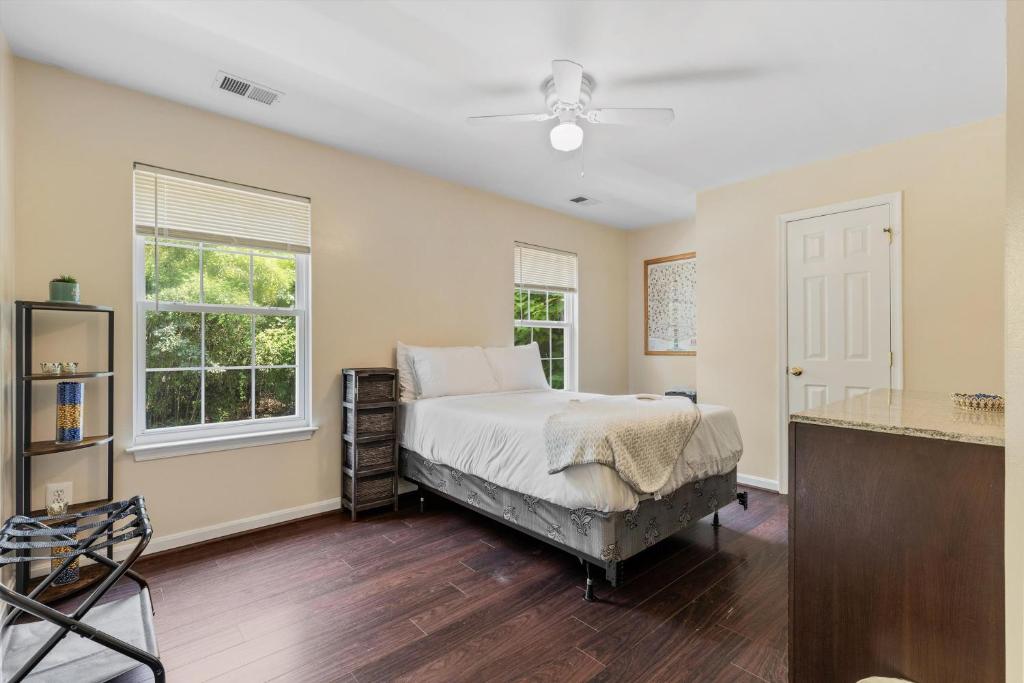 a bedroom with a bed and two windows at Entire 4-BR in Beloved DC Area Takoma Park in Takoma Park