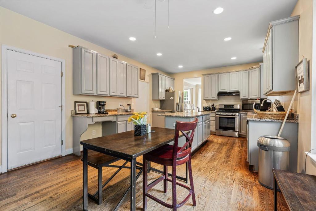 a kitchen with a wooden table and chairs in it at Entire 4-BR in Beloved DC Area Takoma Park in Takoma Park