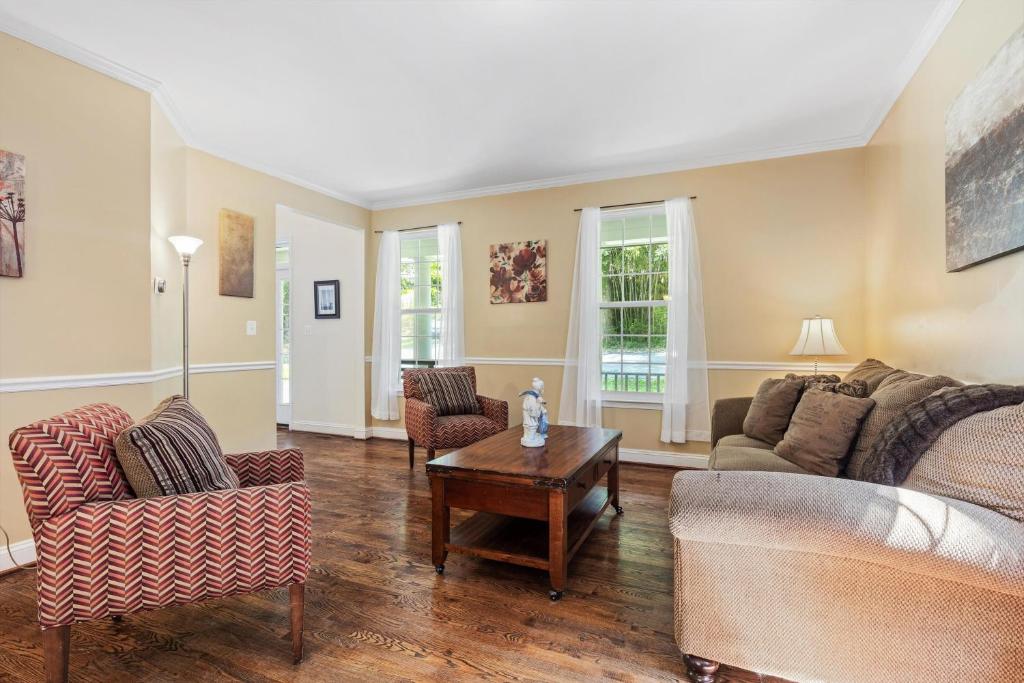 a living room with a couch and a table at Entire 4-BR in Beloved DC Area Takoma Park in Takoma Park