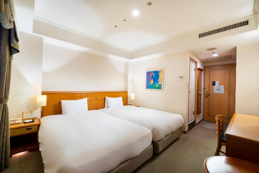 Postel nebo postele na pokoji v ubytování KOKO HOTEL Osaka Shinsaibashi