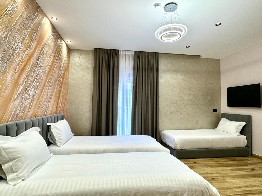 Postel nebo postele na pokoji v ubytování Residence Inn Tirana