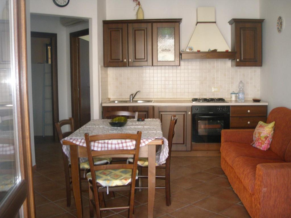 a kitchen with a table and chairs and a couch at Casa Antonella in San Vito lo Capo