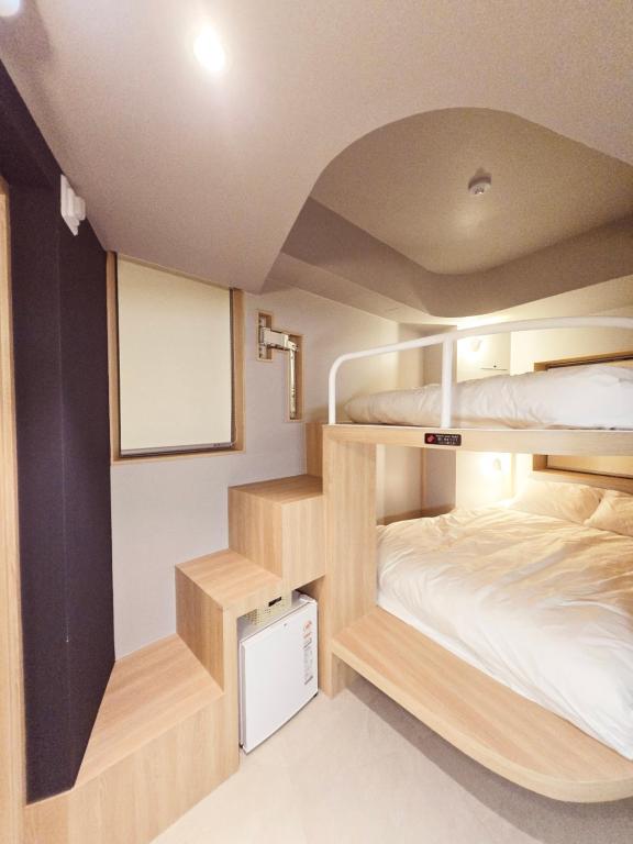 Postel nebo postele na pokoji v ubytování Uhoostay Myeongdong Guesthouse
