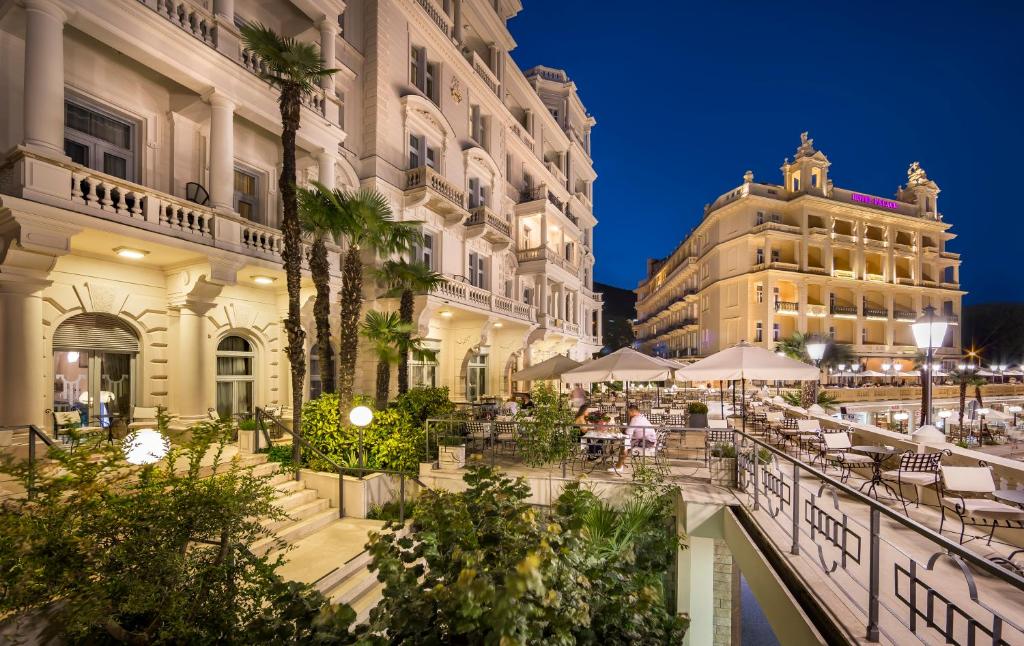 a group of buildings in a city at night at Hotel Bellevue - Liburnia in Opatija