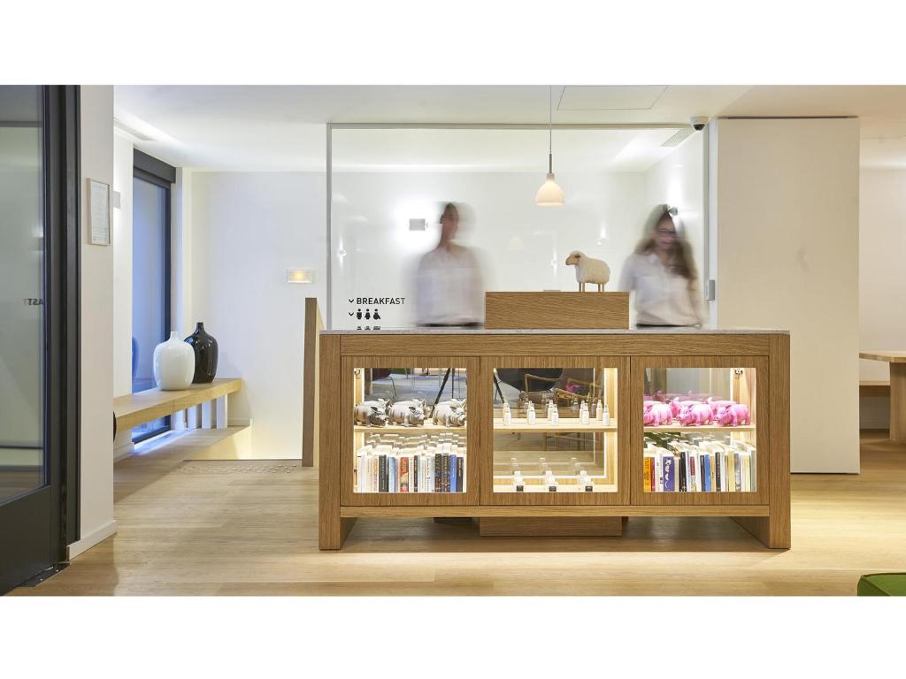 two people standing behind a display case in a store at 9Hotel Republique in Paris