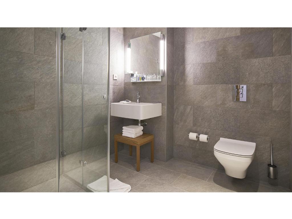 a bathroom with a toilet and a sink and a shower at 9Hotel Republique in Paris