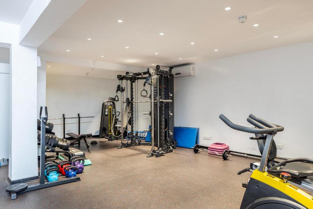 a gym with treadmills and machines in a room at Park Beach Hotel in Limassol