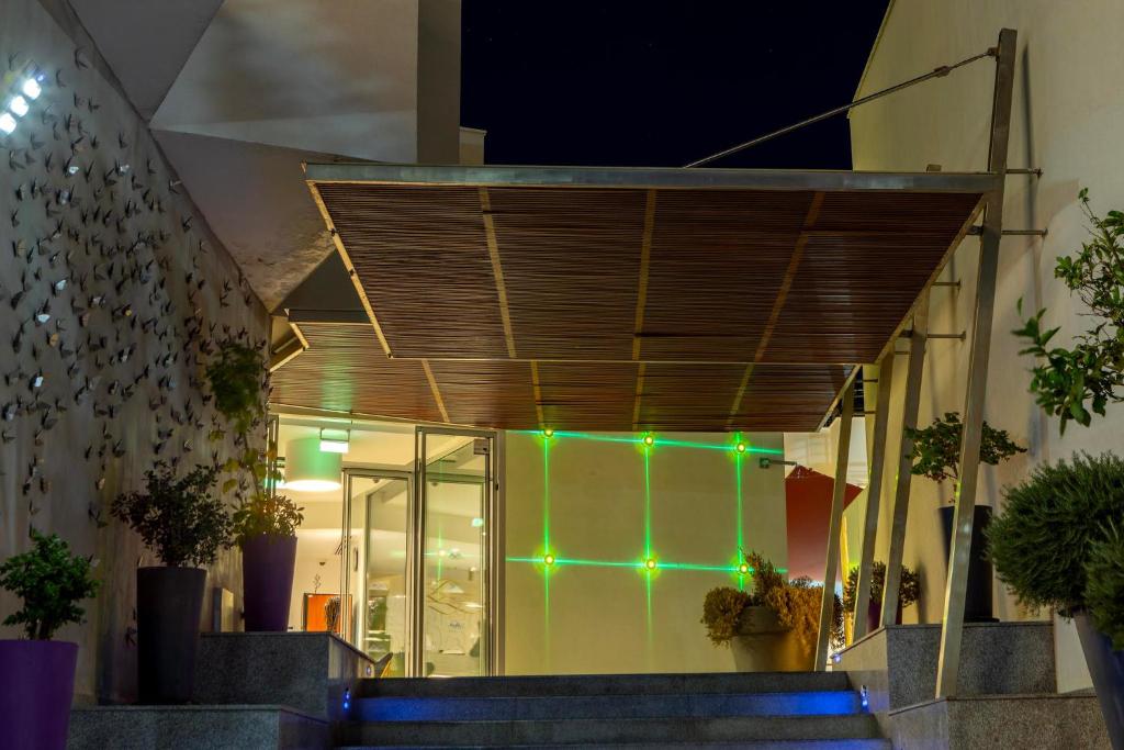 a facade of a building with green lights on it at Park Beach Hotel in Limassol