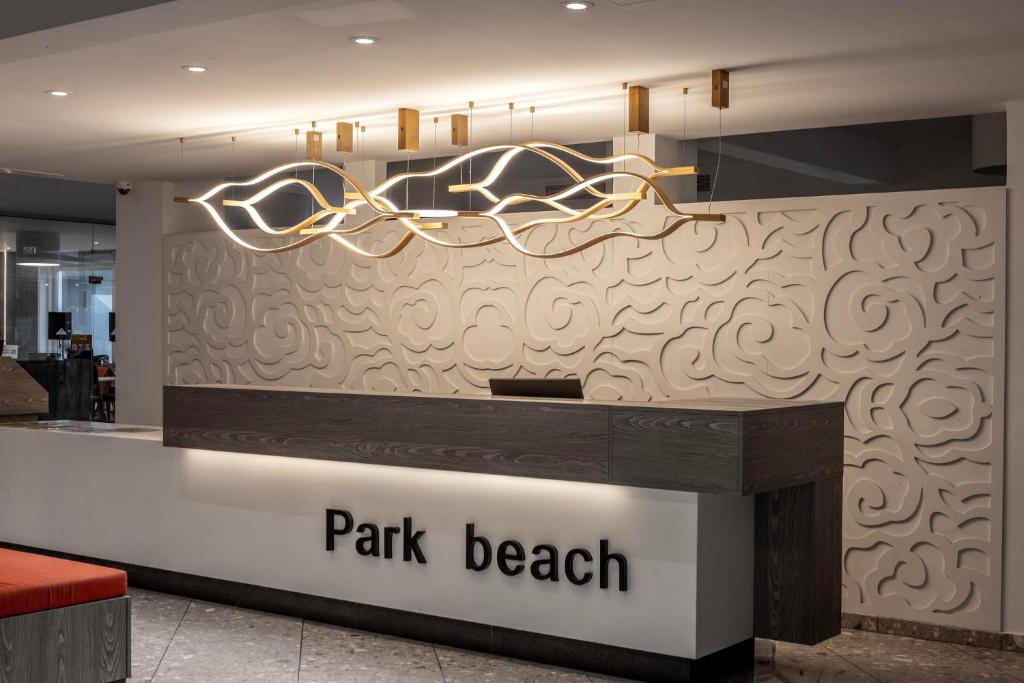 a lobby with a park beak counter in a store at Park Beach Hotel in Limassol