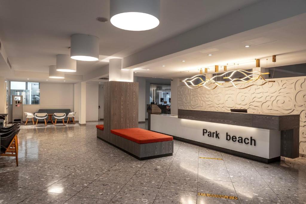 a lobby with a park beach counter in a building at Park Beach Hotel in Limassol