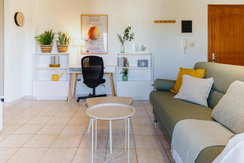 a living room with a couch and a table at The Green - Svolio Hospitality in Komotini