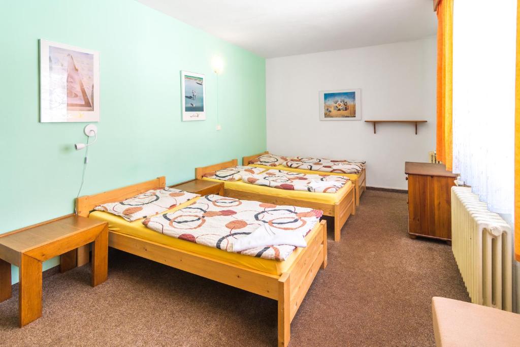 Postel nebo postele na pokoji v ubytování Penzion Vápenka