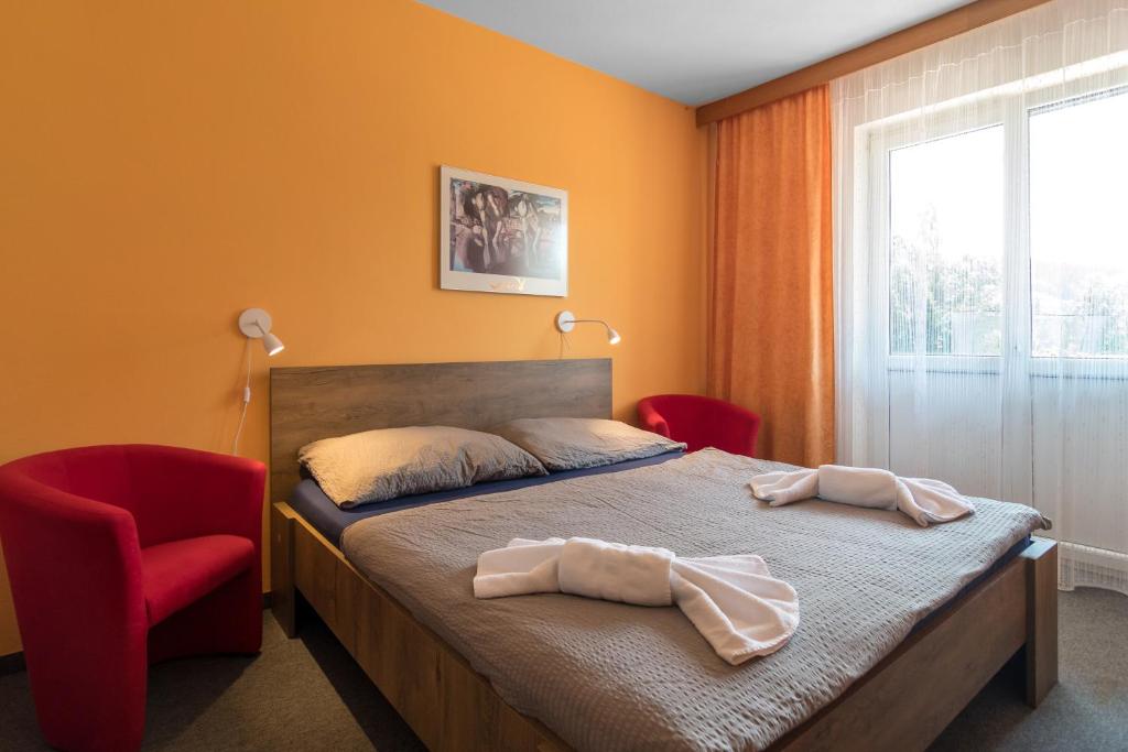 Postel nebo postele na pokoji v ubytování Penzion Vápenka