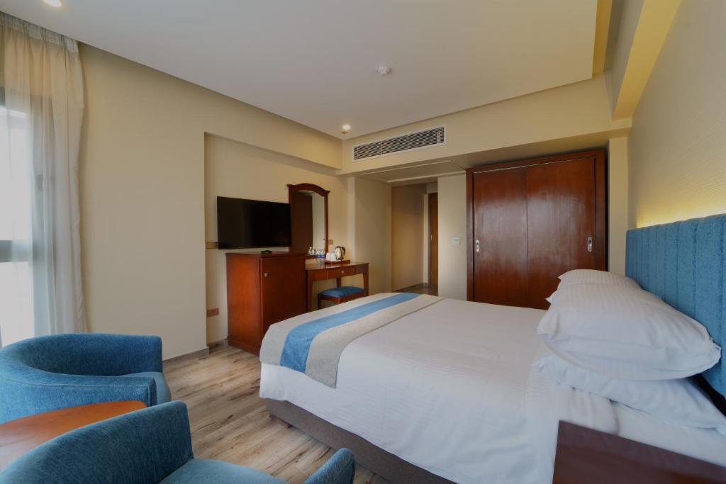 Postel nebo postele na pokoji v ubytování Stay Inn Pyramids Hotel