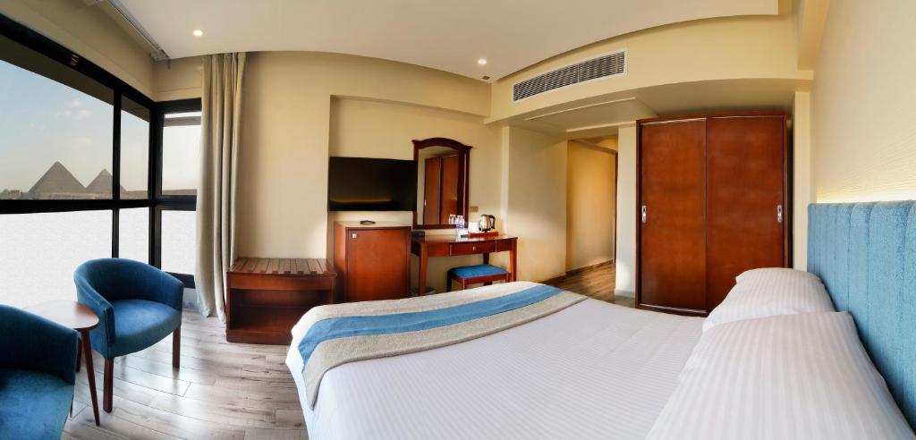 Postel nebo postele na pokoji v ubytování Stay Inn Pyramids Hotel