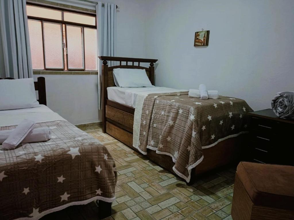 En eller flere senge i et værelse på Casa Bella Tiradentes