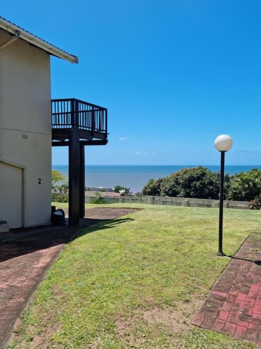 a street light next to a building with the ocean in the background at Home away sea view in Margate